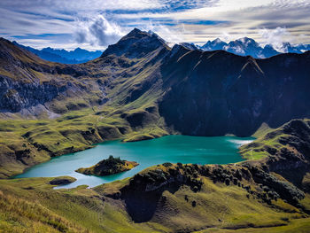 Scenic view of lake and mountains against sky