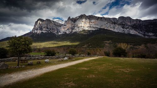 Scenic view of landscape and mountains against sky