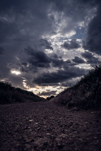 Surface level of land against dramatic sky