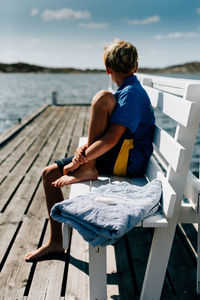 Rear view of man relaxing on beach