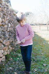 Full length of boy standing on field