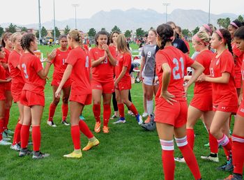 Low angle view of people on soccer field