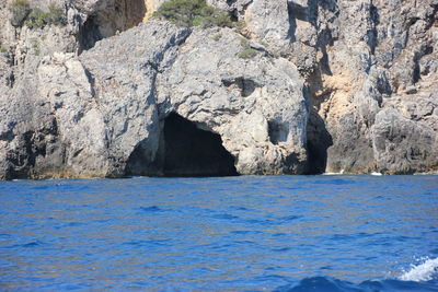 Scenic view of sea against rocks