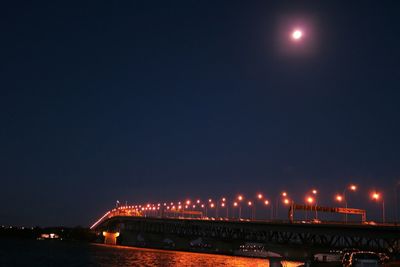 Illuminated lights against sky at night