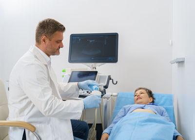 Young doctor examining patient at clinic