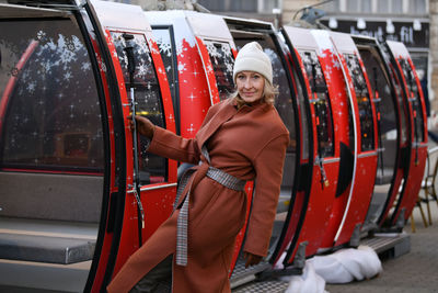 Beatiful woman near the cable car with a gray hair