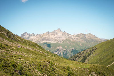 Scenic view of mountains against clear blue sky