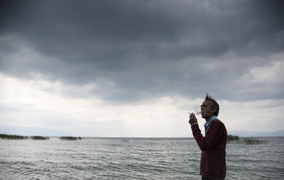 Man smoking cigarette at beach