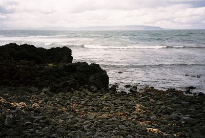 Scenic view of sea against cloudy sky