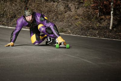 Man longboarding on road