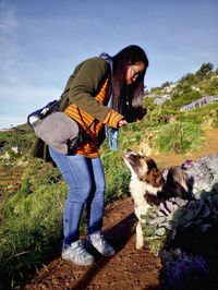 Man with dog against sky