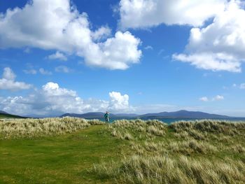 Man on field against sky