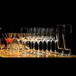 Close-up of wine glasses against black background