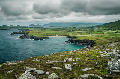 Scenic view of sea and mountains against sky