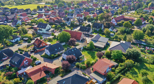 High angle view of houses and trees in town