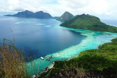 Panoramic view of sea and mountains against sky