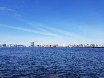 Scenic view of sea and buildings against sky