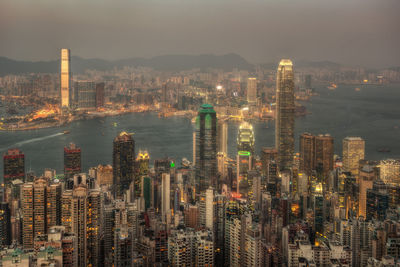 High angle view of illuminated modern buildings in city against sky