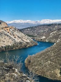 Scenic view of lake and mountains against sky