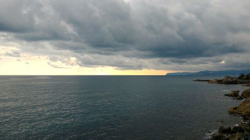 Scenic view of sea against dramatic sky