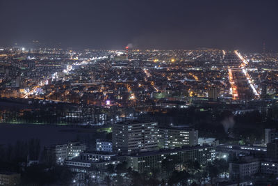 High angle view of illuminated city buildings at night