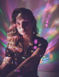 Portrait of woman in illuminated nightclub