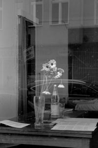 Digital composite image of people on table by window