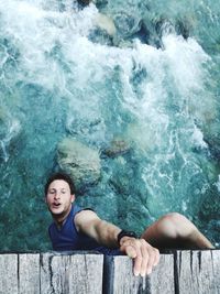 High angle portrait of young woman swimming in pool