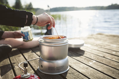 Woman preparing food at lake