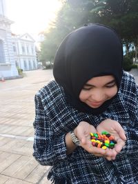 Full length of girl holding hat