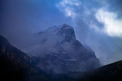 Clearing clouds expose parts of mt temple in lake louise