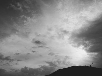 Low angle view of mountain against cloudy sky