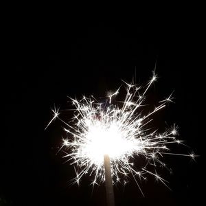 Low angle view of firework display at night