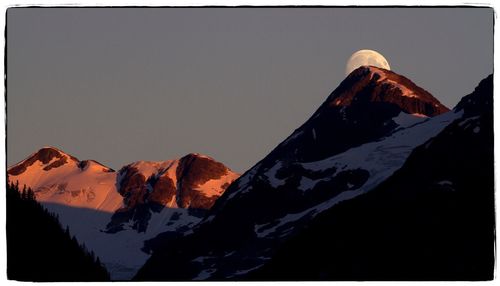 Scenic view of snowcapped mountains against clear sky