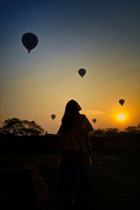 Rear view of silhouette hot air balloon against sky during sunset