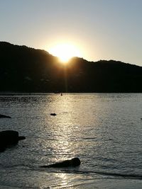 Scenic view of lake against sky during sunset