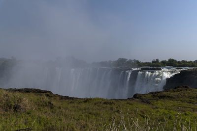 Scenic view of victoria waterfall against sky
