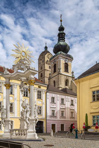 Sculpture of buildings against cloudy sky