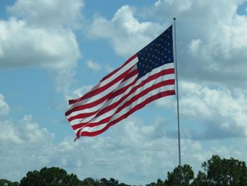 Low angle view of flag against sky