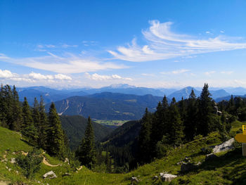 Scenic view of trees and mountains against sky