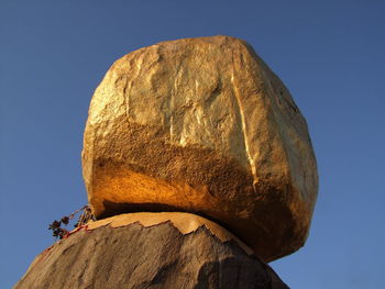 Low angle view of rock against clear sky