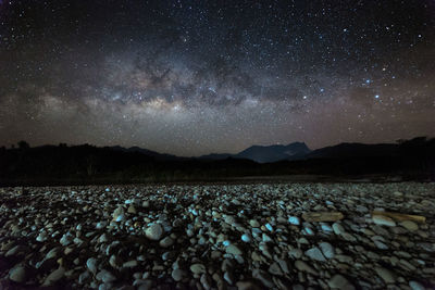 Scenic view of landscape against sky at night