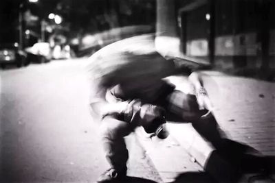 Woman walking on road at night