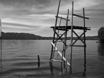 Lifeguard hut on sea against sky