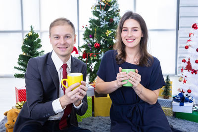Portrait of smiling friends toasting beer glass
