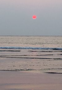 Scenic view of sea against clear sky during sunset