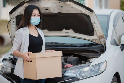 Woman standing in car