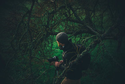 Man in a forest with camera