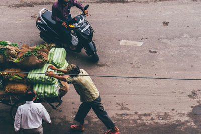 People on street by road