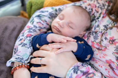 Midsection of baby sleeping outdoors